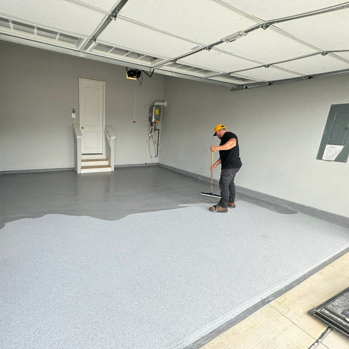 Pouring and spreading epoxy resin for consistent coverage on floors